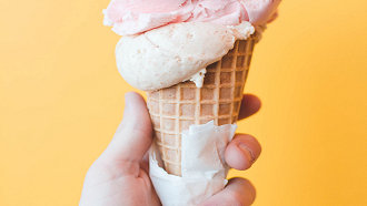 hand holding a drippy ice cream cone