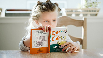 girl reading Hop on Pop book